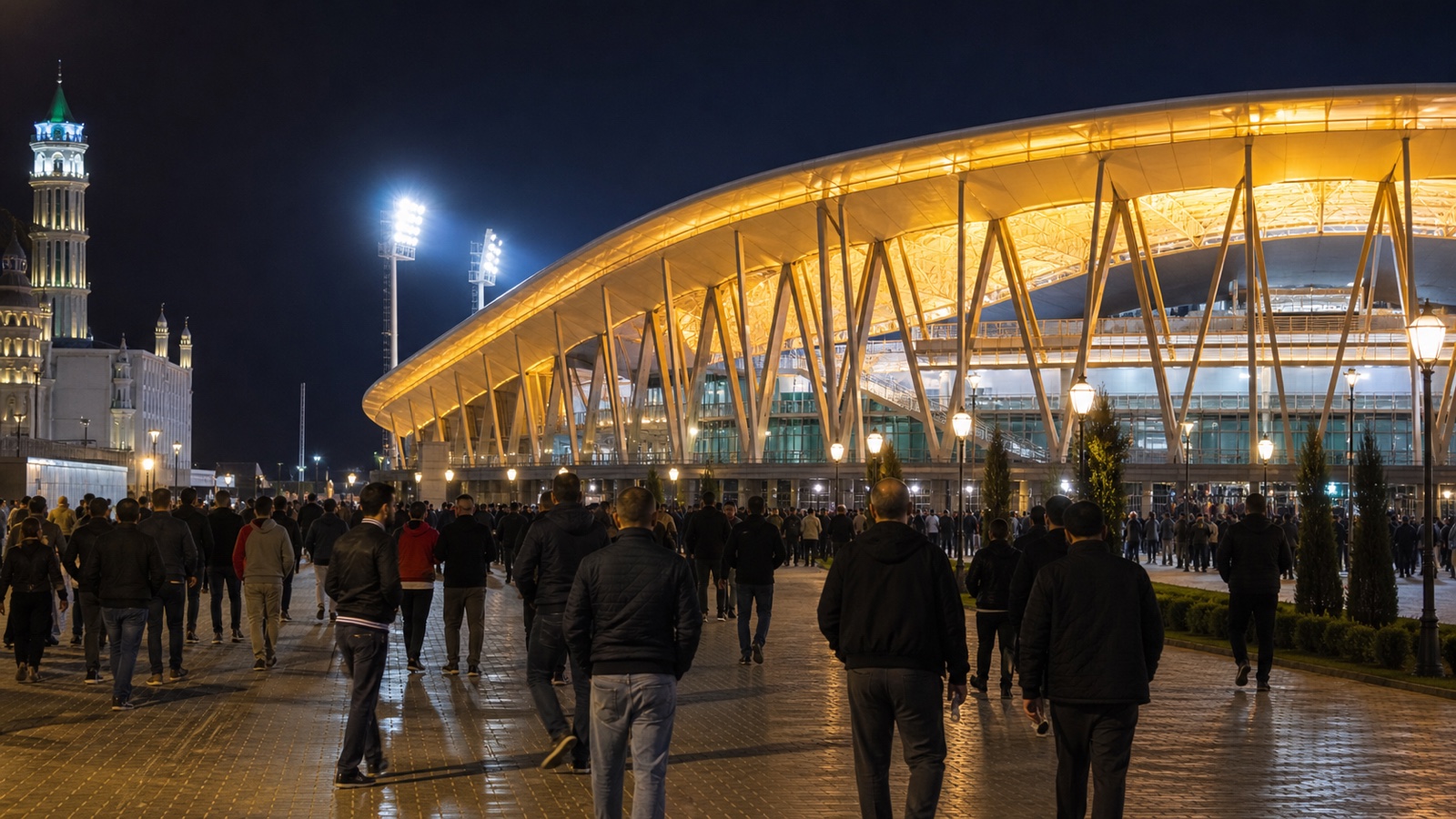 Supporters leaving a football stadium illuminated at night